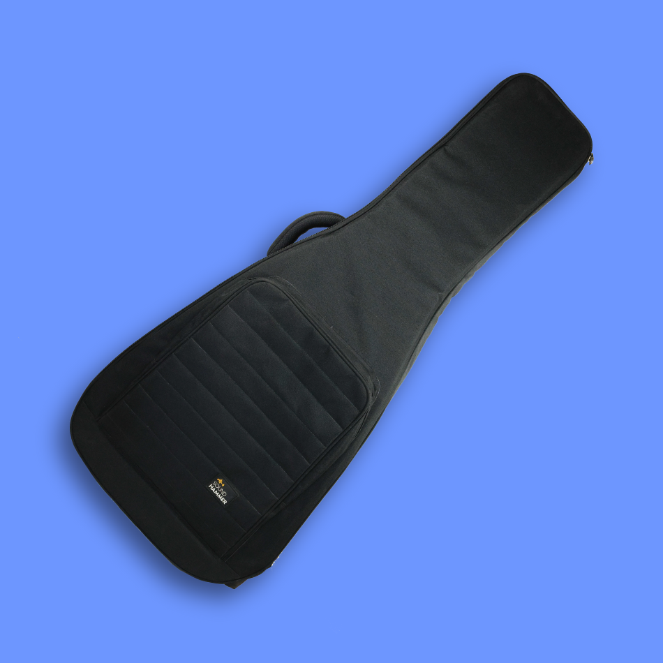 A tilted view of black guitar bag for acoustic guitar with front pouch & carry handle.